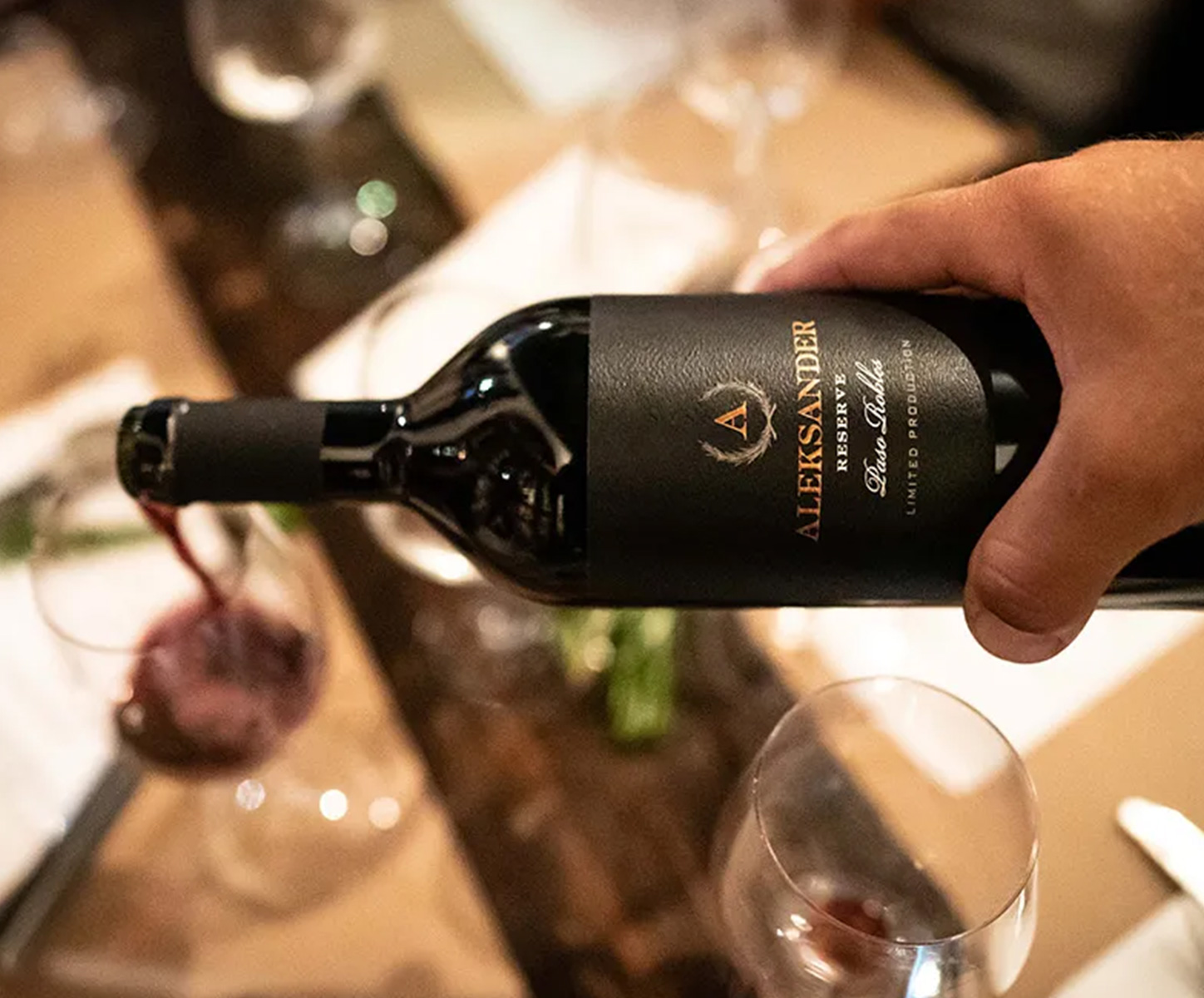 Pouring a bottle of Aleksander Wine